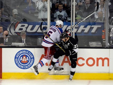 LOS ANGELES, CA - JUNE 13:  Dan Girardi #5 of the New York Rangers checks Dustin Brown #23 of the Los Angeles Kings in the third period during Game Five of the 2014 Stanley Cup Final at Staples Center on June 13, 2014 in Los Angeles, California.