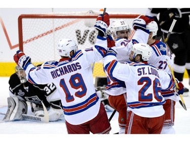 LOS ANGELES, CA - JUNE 13:  Chris Kreider #20 of the New York Rangers celebrates with teammates Brad Richards #19, Derek Stepan #21 and Martin St. Louis #26 after Kreider scores a second period goal past goaltender Jonathan Quick #32 of the Los Angeles Kings during Game Five of the 2014 Stanley Cup Final at Staples Center on June 13, 2014 in Los Angeles, California.