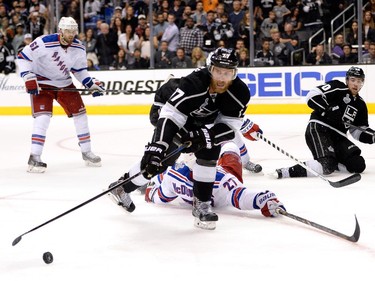 LOS ANGELES, CA - JUNE 13:  Jeff Carter #77 of the Los Angeles Kings goes for the puck against Ryan McDonagh #27 of the New York Rangers in overtime during Game Five of the 2014 Stanley Cup Final at Staples Center on June 13, 2014 in Los Angeles, California.