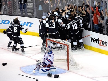 Alec Martinez of the Los Angeles Kings and the Kings celebrate after scoring the game-winning goal in double overtime against goaltender Henrik Lundqvist #30 of the New York Rangers to win 3-2 in Game Five of the 2014 Stanley Cup Final at Staples Center on June 13, 2014 in Los Angeles, California.