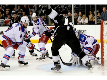 LOS ANGELES, CA - JUNE 13:  Justin Williams #14 of the Los Angeles Kings looks to shoot against Kevin Klein #8 and goaltender Henrik Lundqvist #30 of the New York Rangers in overtime during Game Five of the 2014 Stanley Cup Final at Staples Center on June 13, 2014 in Los Angeles, California.