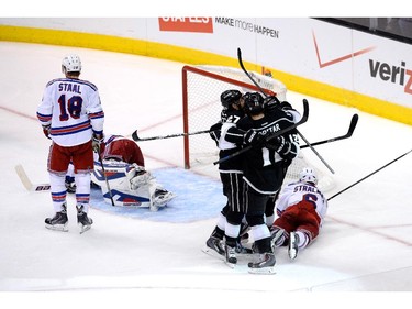 LOS ANGELES, CA - JUNE 13:  Marian Gaborik #12 of the Los Angeles Kings celebrates his third period goal with teammates Alec Martinez #27, Anze Kopitar #11 and Jeff Carter #77 against the New York Rangers during Game Five of the 2014 Stanley Cup Final at Staples Center on June 13, 2014 in Los Angeles, California.