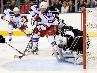 LOS ANGELES, CA - JUNE 13:  Carl Hagelin #62 of the New York Rangers with the puck against Jonathan Quick #32 of the Los Angeles Kings in the third period during Game Five of the 2014 Stanley Cup Final at Staples Center on June 13, 2014 in Los Angeles, California.