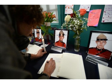 A book of condolence is signed at the Codiac RCMP detachment in Moncton, N.B. on Friday, June 6, 2014 to pay respect to the three RCMP officers who were killed and the two injured in a shooting spree on Wednesday. Justin Bourque, 24, is facing three charges of first-degree murder and two charges of attempted murder.THE CANADIAN PRESS/Sean Kilpatrick