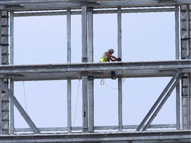 A construction worker works on the new scoreboard for the CFL Redblacks at TD Place stadium in Ottawa on June 29, 2014.