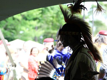 A dancer is silhouetted under a tent at the Summer Soltice Aboriginal Festival at Vincent Massey Park on Saturday.