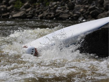 A paddler loses control and capsizes at the first Ontario canoe slalom race of the year, at the Pumphouse downtown Ottawa on June 29, 2014. Many of these paddlers have hopes of representing Ontario at the PanAm games in 2015, while others are local recreational paddlers racing for the first time.