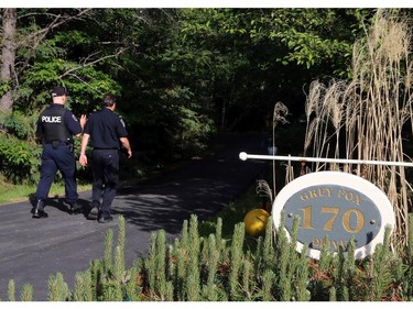 A police and fire investigator walk into the scene of a fire and death at 170 Grey Fox Dr. in Corkery (Ottawa), Sunday, June 8, 2014.