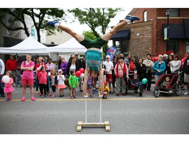 A street performer entertains a crowd along Richmond rd. in Westboro in Ottawa, during Westfest on Saturday, June 14, 2014.