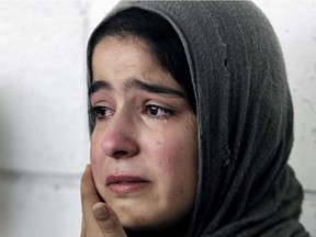 A Syrian refugee girl weeps during the visit of United Nations High Commissioner for Refugees (UNHCR) Antonio Guterres to Khaldeh, south of Beirut, Lebanon, Thursday, June 19, 2014.