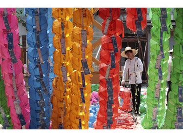 A worker prepares to remove lanterns after a period of celebrations of Buddha's birthday at the Chogye Temple in Seoul, South Korea, Friday, June 13, 2014.