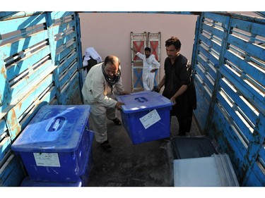 Afghan election commission workers load plastic ballot boxes onto a truck at a warehouse in Jalalabad on June 12, 2014.  Afghanistan's election will go to a run-off vote between former foreign minister Abdullah Abdullah and ex-World Bank economist Ashraf Ghani, results confirmed, as the country enters a new era without NATO combat troops. The head-to-head election, scheduled for June 14, will choose a successor to President Hamid Karzai in Afghanistan's first democratic transfer of power.