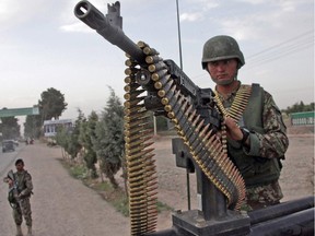 Afghanistan National Army soldiers stand alert in a street in Herat, west of Kabul, Afghanistan, Friday, June 13, 2014. With fears of violence high, Afghanistan braced for a final election on Saturday to choose a new president to replace the only leader the nation has known since the Taliban were ousted and guide the transition to a country that will have to wean itself off near-total dependence on international aid after foreign combat troops withdraw at the end of this year.