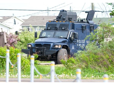 An RCMP armoured vehicle moves to a location in Moncton, N.B., Thursday, June 5, 2014 as the search for a heavily armed gunman suspected to have shot three Mounties dead and injured two others continues.