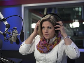 NDP Leader Andrea Horwath dons a pair of headphones as she prepares to appear on the radio station Newstalk 1010, in Toronto.