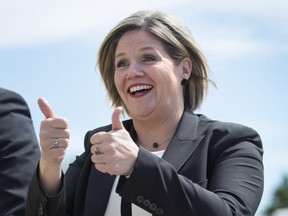 Ontario NDP Leader Andrea Horwath gestures toward a group of supporters while campaigning in Ajax, Ont. on Wednesday, June 4, 2014.