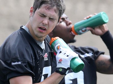 Antoine Pruneau #6 of the Ottawa Redblacks squirts some water on his face during a practice at TD Place stadium in Ottawa on June 29, 2014.