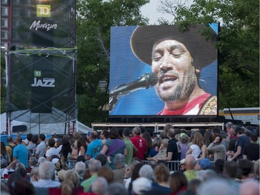 Ben Harper is seen on a jumbotron screen as he performs with Charlie Musselwhite on the Main Stage at the Ottawa Jazz Festival on Friday, June 27, 2014.