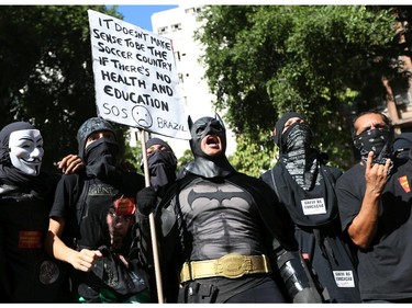 RIO DE JANEIRO, BRAZIL - JUNE 12:  A person in a Batman costume holds a sign during a World Cup demonstration on June 12, 2014 in Rio de Janeiro, Brazil. This is the first day of World Cup play.
