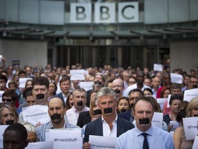 BBC staff and colleagues from other news organisations take part in a one-minute silent protest outside New Broadcasting House against the seven-year jail terms given to three al-Jazeera journalists in Egypt.