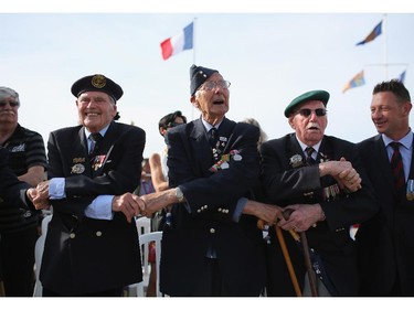 ARROMANCHES LES BAINS, FRANCE - JUNE 06:  Normandy veterans sing Auld Lang Syne at the end of the 70th anniversary of the D-Day landings on June 6, 2014 in Arromanches Les Bains, France.  Friday 6th June is the 70th anniversary of the D-Day landings which saw 156,000 troops from the allied countries including the United Kingdom and the United States join forces to launch an audacious attack on the beaches of Normandy, these assaults are credited with the eventual defeat of Nazi Germany. A series of events commemorating the 70th anniversary are planned for the week with many heads of state travelling to the famous beaches to pay their respects to those who lost their lives.