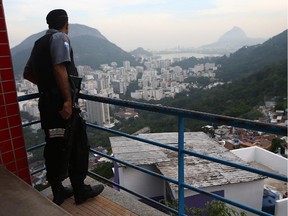 A UPP (Police Pacification Unit) officer keeps watch in the Santa Marta shantytown, or 'favela', on June 7, 2014 in Rio de Janeiro, Brazil.