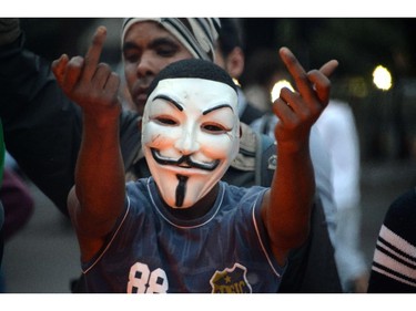 Demonstrators gesture at riot police during a protest against the 2014 FIFA World Cup in Belo Horizonte, Brazil on June 12, 2014.
