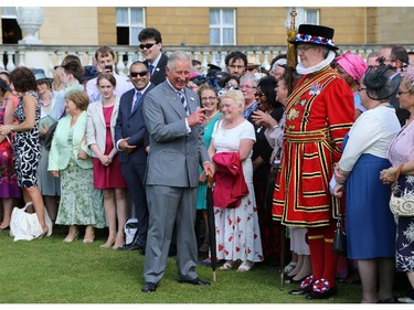 Britain's Prince Charles, Prince of Wales, president of the British Red Cross, meets guests during a garden party in the grounds of Buckingham Palace in central London, on June 12, 2014 in honour of the British Red Cross.