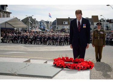 Britain's Prince William, Duke of Cambridge, lays a wreath at an event for veterans in Arromanches-les-Bains, western France, Friday, June 6, 2014, marking the 70th anniversary of the World War II Allied landings in Normandy. World leaders and veterans gathered by the beaches of Normandy on Friday to mark the 70th anniversary of World War Two's D-Day landings.