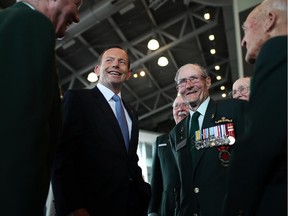 Australian Prime Minister Tony Abbott (2L) chats with Korean War Veterans at the Canadian War Museum in Ottawa, Canada on June 8, 2014. This marks Prime Minister Abbott's first official visit to Canada.