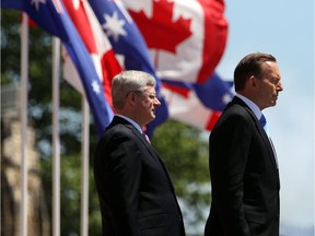 Australian Prime Minister Tony Abbot, right, in Ottawa to meet with Prime Minister Stephen Harper, said climate change is not the 'most important problem the world faces.'