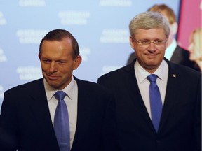 Canadian Prime Minister Stephen Harper (right) and Australian Prime Minister Tony Abbott (left) make their way to a dinner hosted by Harper in Ottawa, Monday June 9 2014.
