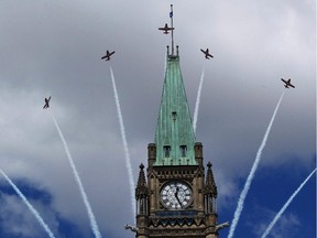Canadian Snowbirds fly over top of the Peace Tower during Canada Day celebrations in Ottawa on July 1, 2011. THE CANADIAN PRESS/Fred Chartrand