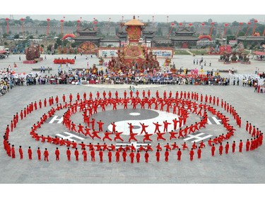 People perform "tai chi" during the launching ceremony of the 12th Handan International Tai Chi Conference in Handan, north China's Hebei province on June 13, 2014. Over 1700 tai chi practitioners from around the world gathered in Handan to attend the International Tai Chi Conference that includes tai chi competitions, seminars and tai chi culture tours, local media reported.  CHINA OUT