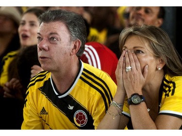 Colombia's President and presidential candidate Juan Manuel Santos (L) and his wife Maria Clemencia react while watching the FIFA World Cup match between Colombia and Greece on TV, in Bogota, Colombia, on June 14, 2014. Santos, elected for the period 2010-2014, will run against the candidate of the Democratic Center party Oscar Ivan Zuluaga in the presidential run-off on June 15.