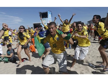 Colombia soccer fans celebrate their team's goal against Greece as they watch the World Cup game inside the FIFA Fan Fest area on Copacabana beach in Rio de Janeiro, Brazil, Saturday, June 14, 2014.