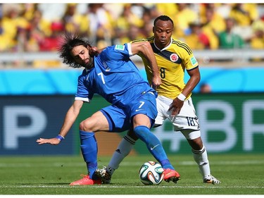 Giorgos Samaras of Greece fights off Juan Camilo Zuniga of Colombia during the 2014 FIFA World Cup Brazil Group C match between Colombia and Greece at Estadio Mineirao on June 14, 2014 in Belo Horizonte, Brazil.