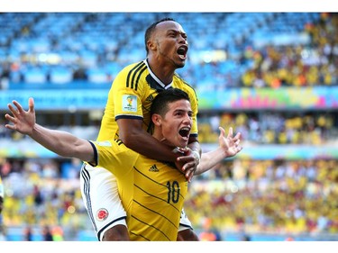 James Rodriguez of Colombia celebrates scoring his teams third goal with Juan Camilo Zuniga during the 2014 FIFA World Cup Brazil Group C match between Colombia and Greece at Estadio Mineirao on June 14, 2014 in Belo Horizonte, Brazil.