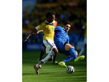 Juan Guillermo Cuadrado of Colombia and Andreas Samaris of Greece battle for the ball during the 2014 FIFA World Cup Brazil Group C match between Colombia and Greece at Estadio Mineirao on June 14, 2014 in Belo Horizonte, Brazil.