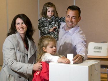 Conservative candidate Matt Young, right, is jointed by his wife Allison, daughters Juliette, lower centre, and Isabelle as they take part in voting at Tudor Hall polling station off of Riverside Drive on Thursday, June 12, 2014.