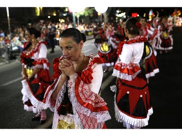 Dancers of the Mouraria neighborhood wait for their performance contest during Saint Anthony festivities, in Lisbon, Thursday, June 12, 2014. During the contest, Lisbon's neighborhood groups compete for the best performance, costume design, music and choreography. People celebrate the festivities of the Day of Saint Anthony, who is the Lisbon's patron saint, by dancing and eating outside in colorfully decorated downtown streets.