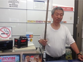 Dehou Xiao, 68,with the broom he used to fight off an attempted robbery earlier this month at his Glebe store last month.