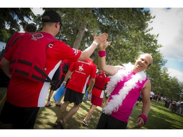 Dylan Meuser cheers teams on as they head towards the boats at The 21st Tim Hortons Ottawa Dragon Boat Festival took place this past weekend at Mooney's Bay Park. (Ashley Fraser / Ottawa Citizen)