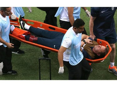 MANAUS, BRAZIL - JUNE 14:  England trainer Gary Lewin is stretchered off the field after a leg injury during the 2014 FIFA World Cup Brazil Group D match between England and Italy at Arena Amazonia on June 14, 2014 in Manaus, Brazil.
