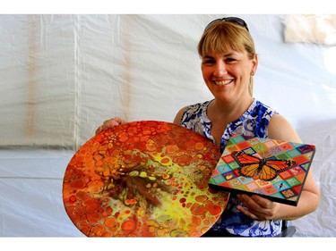 Evelyne Power shows two pieces of art she bought at the New Art Festival at Central Park in the Glebe.