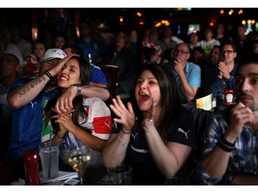 Fans watch the England v. Italy World Cup soccer match on Saturday, June 14, 2014 at Heart and Crown bar in Little Italy.
