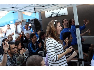 Fans watch the England v. Italy World Cup soccer match on Saturday, June 14, 2014 at Allegro Ristorante on an outdoor screen in Little Italy.