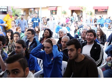 Fans watch the England v. Italy World Cup soccer match on Saturday, June 14, 2014 at Allegro Ristorante on an outdoor screen in Little Italy.