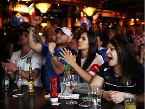 Fans watch the England vs. Italy World Cup soccer match on Saturday, June 14, 2014 at Heart and Crown bar in Little Italy.