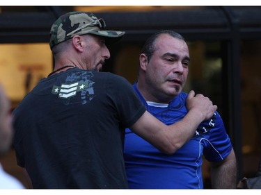 Father of murdered teen Brandon Volpi, Danny holds hack tears as Brandon's friends swap stories and mourn their classmate, friend, and family member at a vigil out front of Les Suites in Ottawa on Sunday, June 8, 2014.